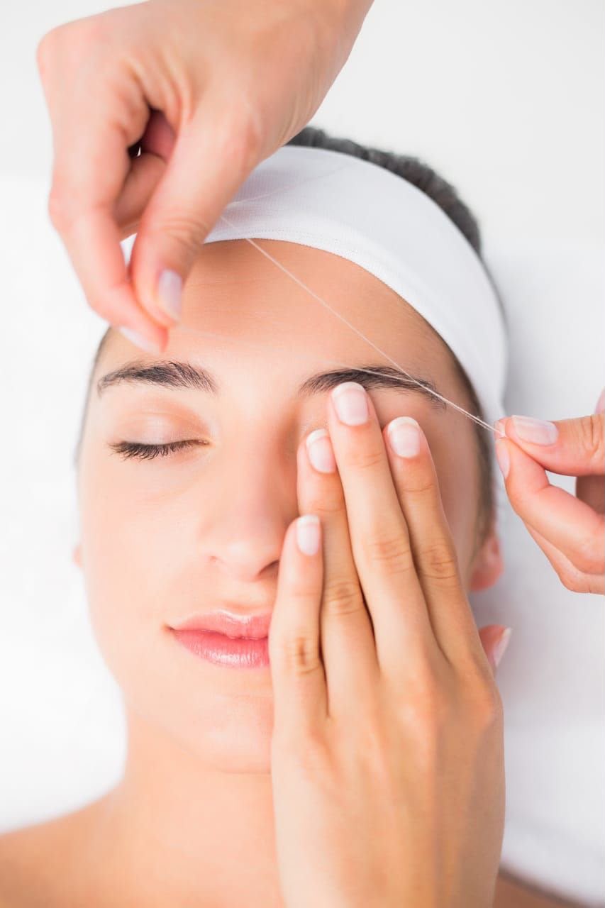 Eyebrow threading and shaping treatment